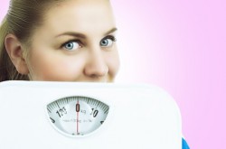 woman with floor scales, isolated against white background