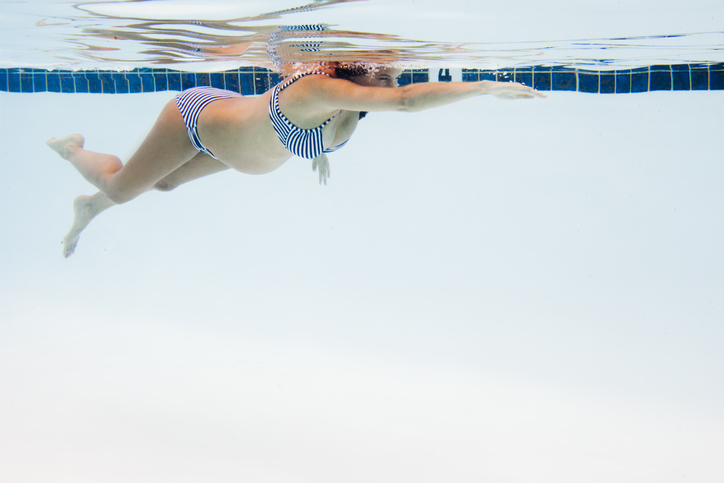 Pregnant Woman Swimming in Pool